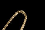 Collier en or jaune 18k (750 millièmes) à maille tressée...